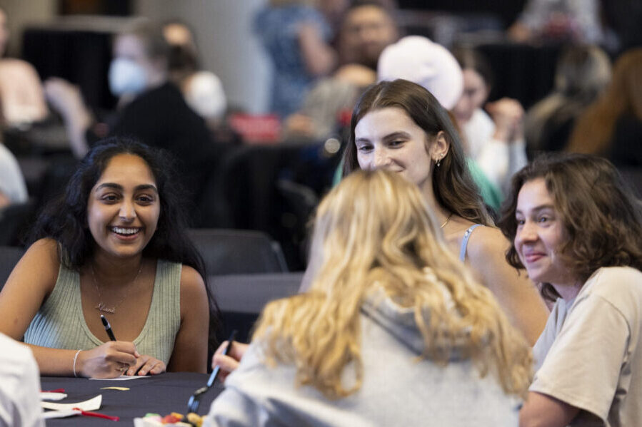 Students enjoy food and socializing at the Transfer Student Welcome at the West End Zone Recruiting Lounge on the first day of class.